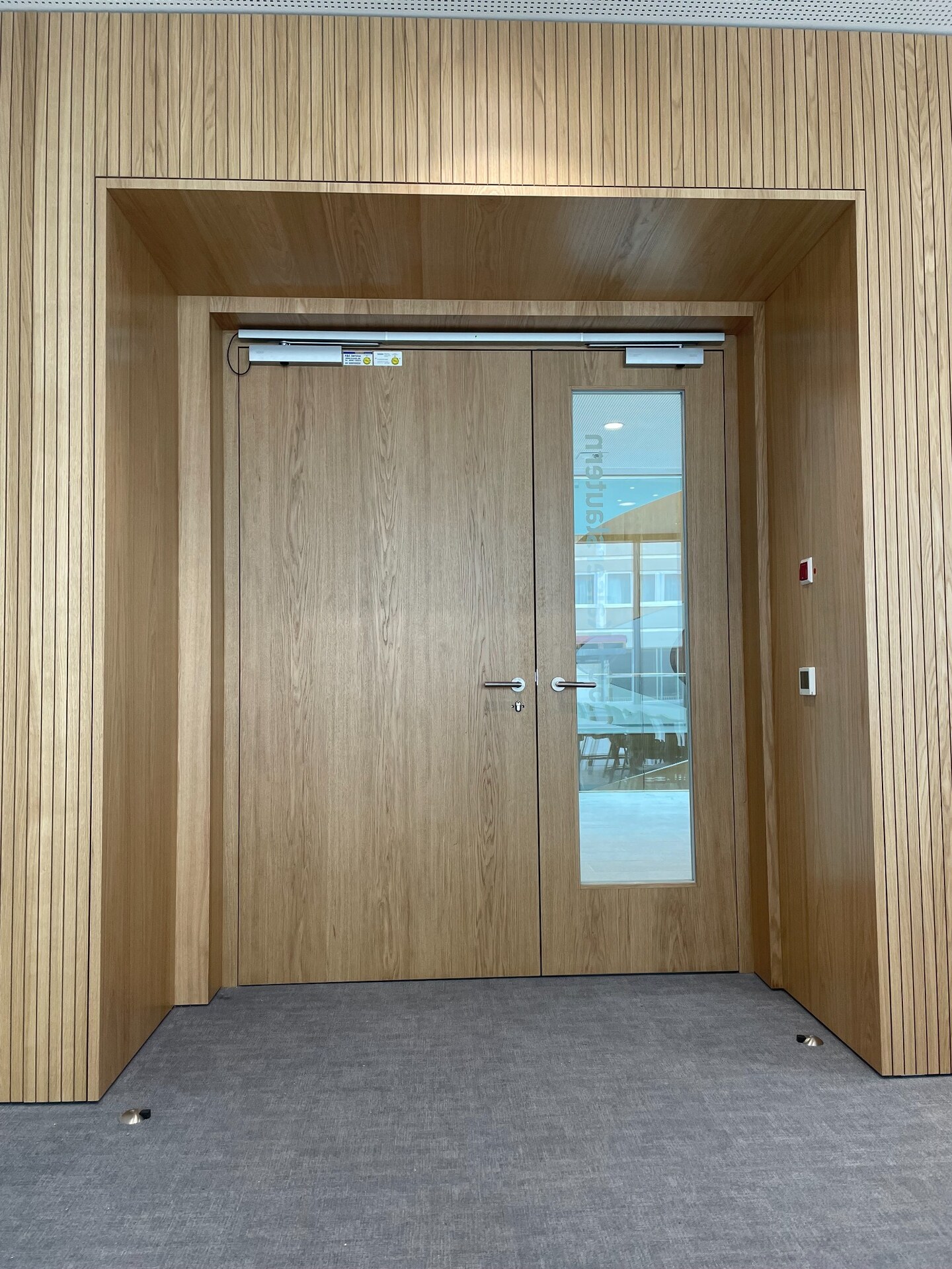 Türportal mit Wandverkleidung in Lamellenoptik aus Eiche